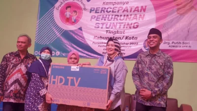 SERAHKAN HADIAH. Anggota Komisi IX DPR RI dari Fraksi Gerindra drg. Putih Sari saat menyerahkan hadiah doorprize kepada peserta sosialisasi percepatan penurunan stunting yang beruntung. ADAM SUMARTO/PASUNDAN EKSPRES