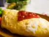 Resep Omurice Korea, Kreasi Nasi Goreng Dibalut Telur Cocok Buat Sarapan (image from screenshot YouTube dapur oishi)